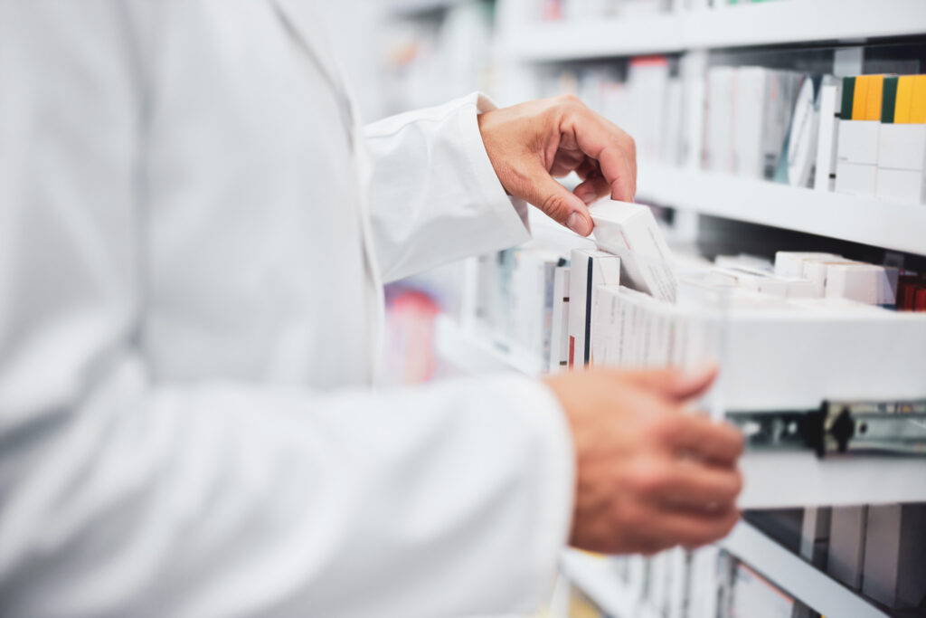 A pharmacist opening a drawer of new antibiotics 