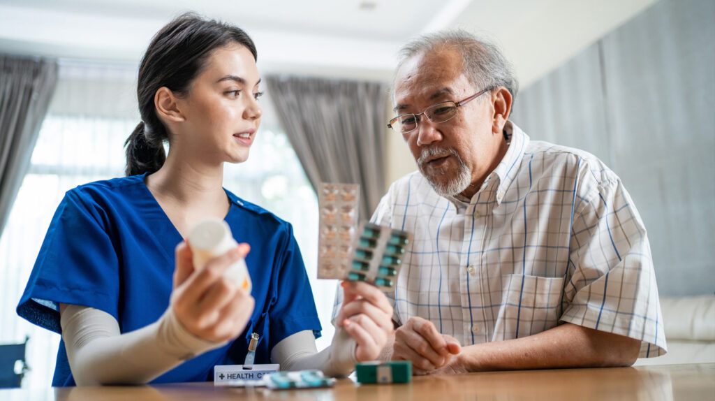 A young prescriber advises an elderly patient on antimicrobial options