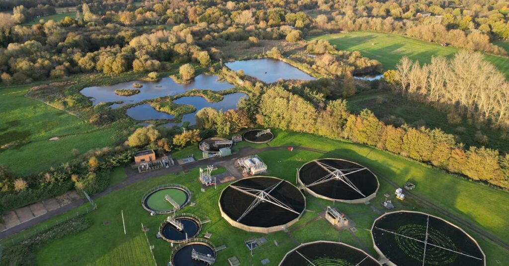 Drone shot of a picturesque rural water treatment plant surrounded by nature.