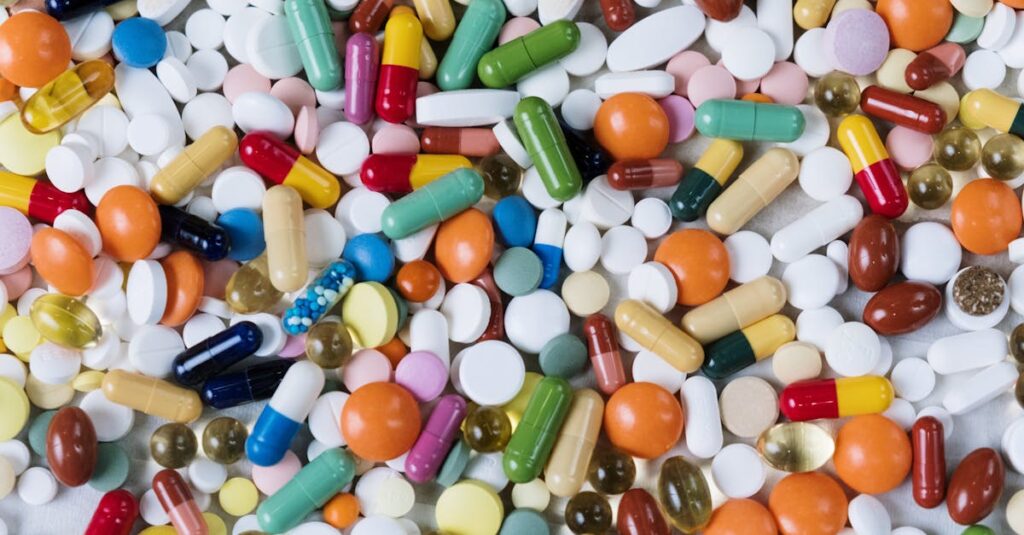 Vibrant assortment of medicine capsules and tablets in a flatlay format, highlighting diversity in pharmaceuticals.